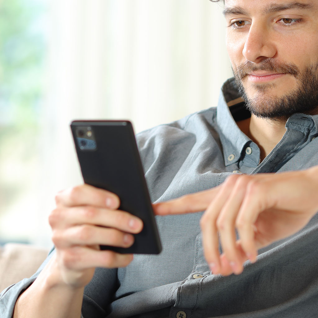 Business professional checking a phone, representing a client reviewing an AI-automated workflow.