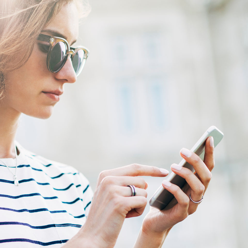 Business professional checking a phone, representing a client reviewing an automated workflow.